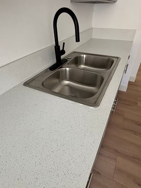 Los Angeles apartment for rent - A kitchen sink with a black faucet.