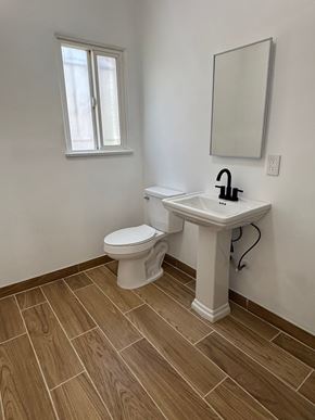 Los Angeles apartment for rent - A white toilet sits next to a sink in a bathroom.