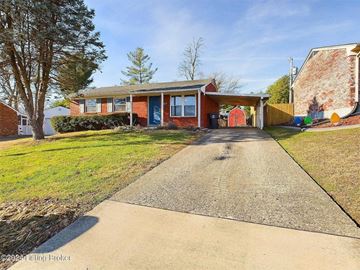 New Albany house for rent - A red brick house with a gravel driveway in front.