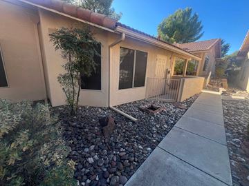 Cottonwood house for rent - A house with a red tile roof and a small garden in front.