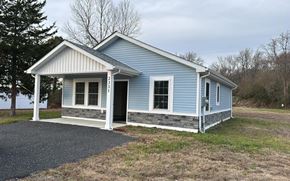 Pocomoke City house for rent - A small blue house with a white door and windows.