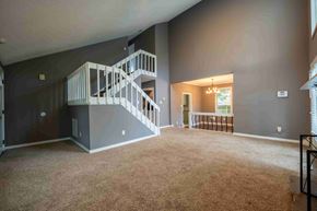 Fayettevile house for rent - A spacious room with a staircase and a window.