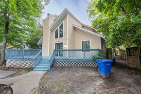 Fayettevile house for rent - A house with a blue trash bin in front of it.