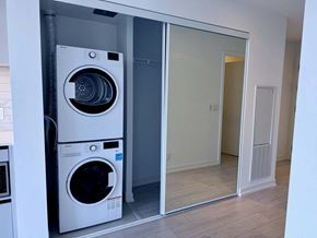 Toronto apartment for rent - A white washing machine and dryer in a laundry room.