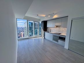 Toronto apartment for rent - A spacious kitchen with a view of the cityscape outside the window.