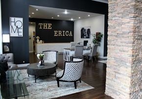 Oklahoma City apartment for rent - A well-equipped home gym with wooden flooring and white walls.