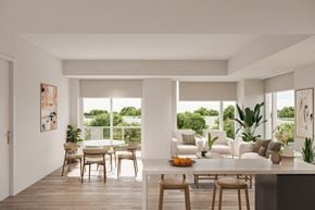 Ottawa apartment for rent - A modern dining room with a table set for two and a view of the backyard.