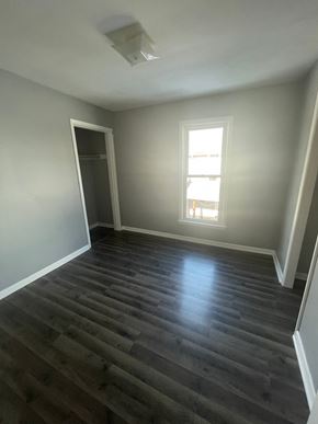 Lima apartment for rent - A room with a wooden floor and a window.