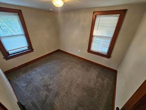 Lima apartment for rent - A room with a carpeted floor and two windows.