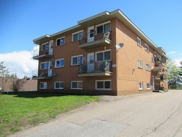 Pembroke apartment for rent - A large brick building with multiple balconies and windows.