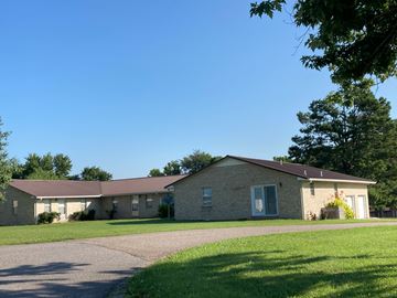 Buchanan apartment for rent - A house with a grey roof and a green lawn in front.