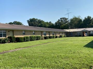 Buchanan apartment for rent - A grassy area in front of a building with a clear blue sky above.