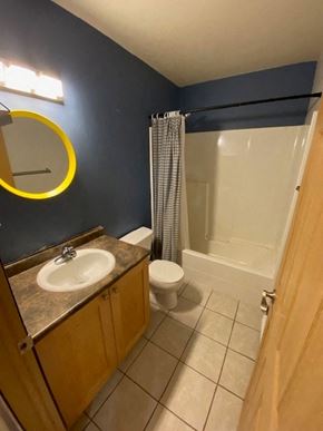 Brandon apartment for rent - A bathroom with a toilet, sink, and shower.