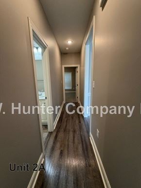 Wilson apartment for rent - A long hallway with Hunter Company written on the wall.