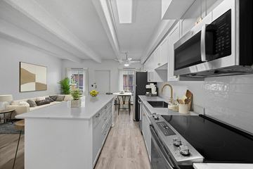 Denver apartment for rent - A parking lot in front of a multi-story apartment building.