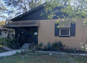 Jacksonville house for rent - A small house with a brown roof and a black door.