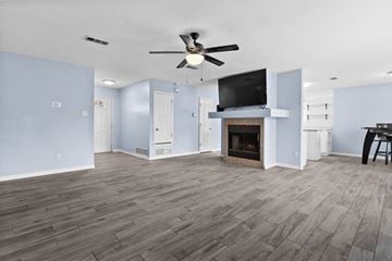 Killeen house for rent - A living room with a fireplace and a television mounted above it.