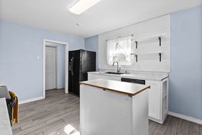 Killeen house for rent - A kitchen with a white counter and a black fridge.