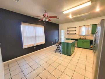 Killeen house for rent - A kitchen with a green cabinet and a fan on the ceiling.