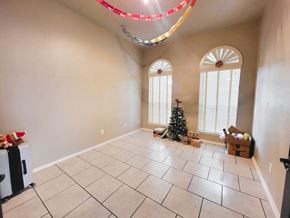 Killeen house for rent - A room with a Christmas tree and presents under a window.