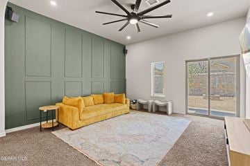 El Paso house for rent - A living room with a yellow couch and a ceiling fan.