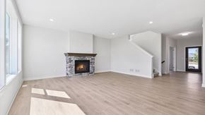 Blaine house for rent - A spacious living room with a fireplace and wooden flooring.