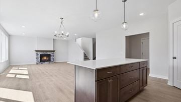 Blaine house for rent - A modern kitchen with dark wood cabinets and a white island.