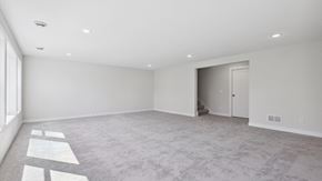 Blaine house for rent - A spacious room with a carpeted floor and a doorway leading to another room.