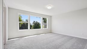 Blaine house for rent - A room with a carpeted floor and a window overlooking trees.