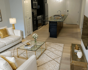 Calgary apartment for rent - A modern living room with a glass coffee table and white sofa.