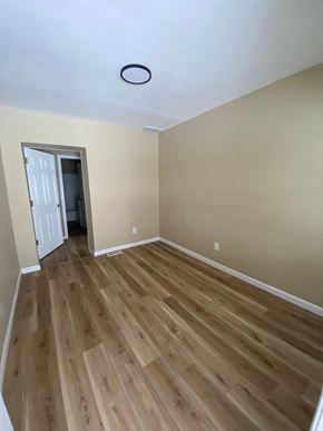 Louisville house for rent - A room with wooden flooring and a white door.