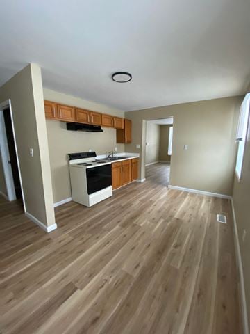 Louisville house for rent - A kitchen with wood flooring and a ceiling fan.