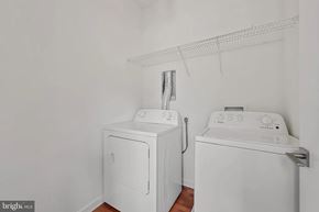 Baltimore house for rent - A white dryer and washer in a laundry room.