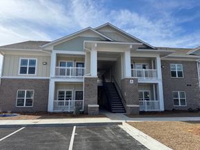 Valdosta apartment for rent - A two-story apartment building with a parking lot in front.