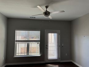 Valdosta apartment for rent - A room with a ceiling fan and two windows.
