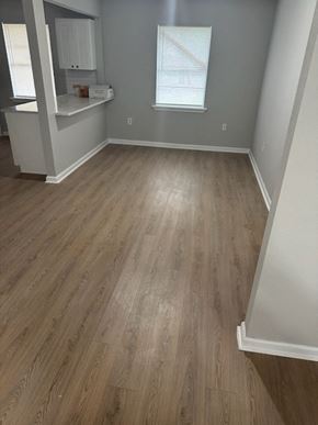 Houston house for rent - A room with wooden flooring and a window with blinds.