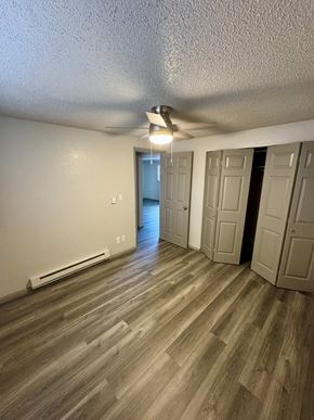 Fountain apartment for rent - A room with wooden flooring and a ceiling fan.