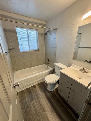 Fountain apartment for rent - A white toilet sits next to a sink in a bathroom.