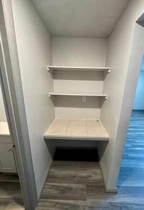 Fountain apartment for rent - A white pantry with a door open to a hallway.
