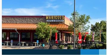 Colorado Springs apartment for rent - The Marigold Cafe & Bakery has a red awning and red umbrellas outside.