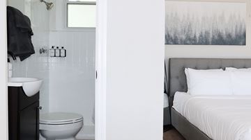 Nashville apartment for rent - A bathroom with a toilet, sink, and a bedroom with a bed.