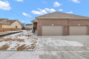 Sterling Heights apartment for rent - A two-car garage with a brick exterior is situated in a residential area.