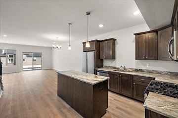 Sterling Heights apartment for rent - A kitchen with wooden cabinets and a marble countertop.