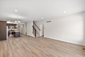 Sterling Heights apartment for rent - A spacious room with wooden flooring and a staircase.