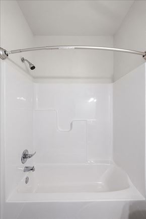 Sterling Heights apartment for rent - A white bathroom with a tub and shower head.