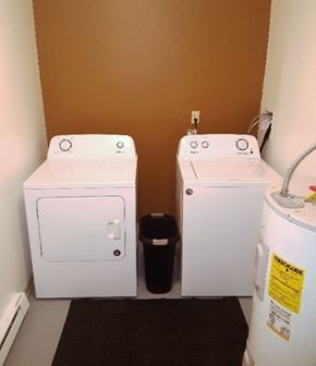 Colorado Springs apartment for rent - Two white washing machines in a small room.