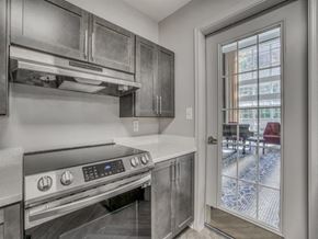 Germantown apartment for rent - A modern kitchen with a stainless steel oven and a glass door leading to a balcony.
