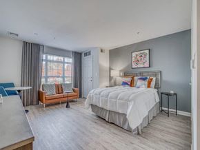 Germantown apartment for rent - A bedroom with a large bed and a window with curtains.