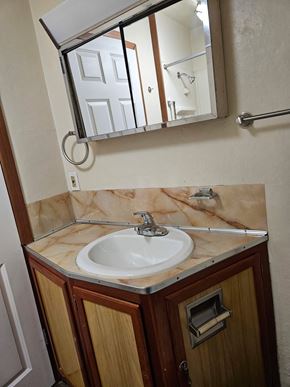 Everett house for rent - A bathroom with a marble counter top and a mirror above the sink.