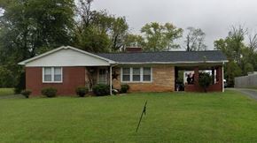 Mount Airy house for rent - A house with a red brick exterior and a grey roof.